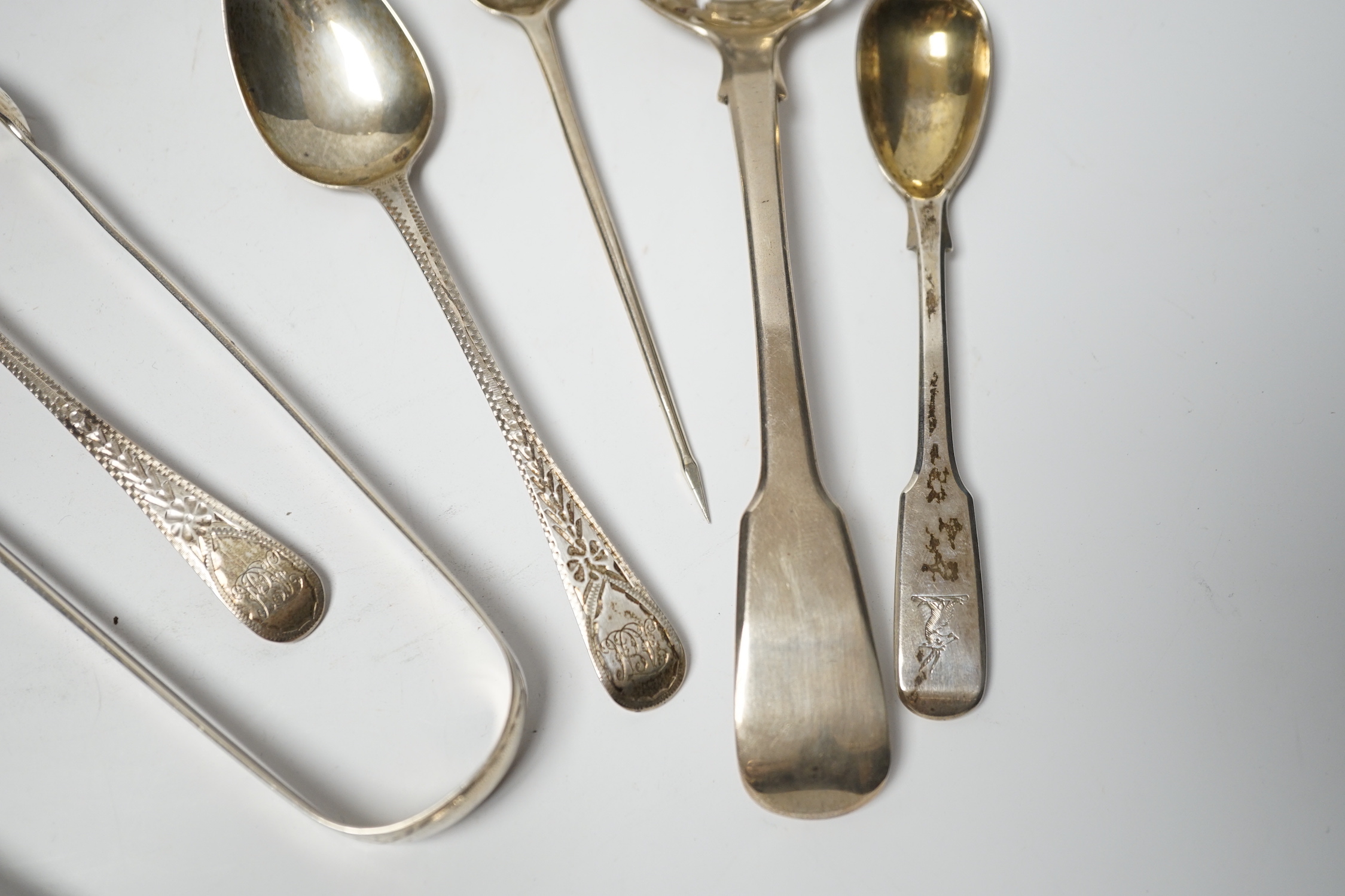 An 18th century silver mote spoon, marks rubbed, 11.8cm and five other various silver spoons and a pair of silver sugar tongs, 5.1oz.